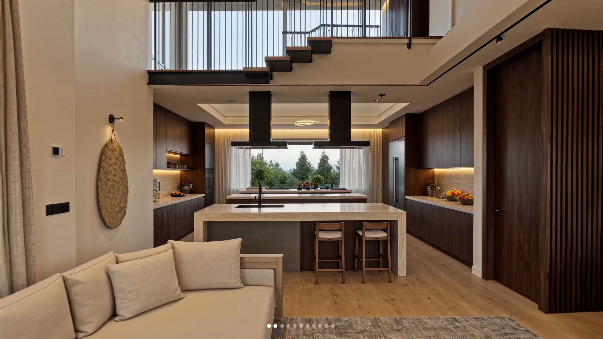 Double-height great room with kitchen island and stair to mezzanine