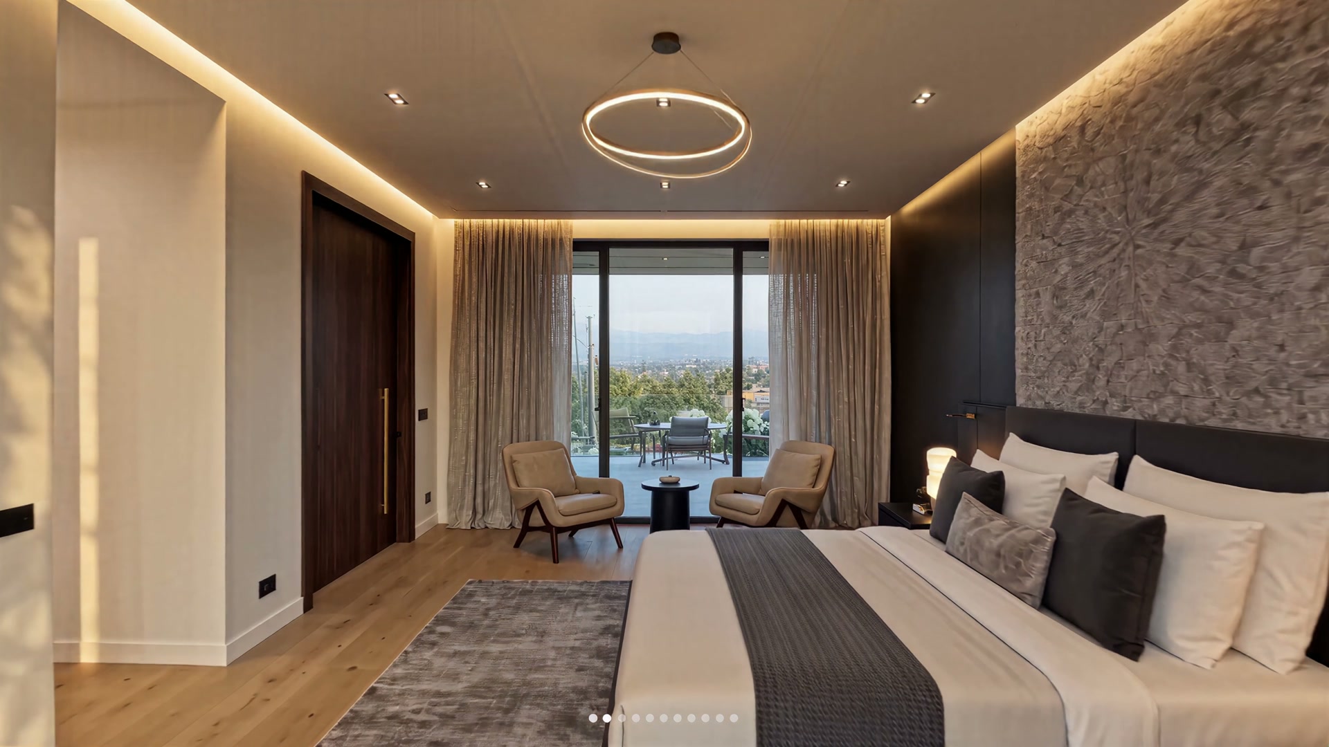 Primary bedroom suite with ring pendant and valley balcony
